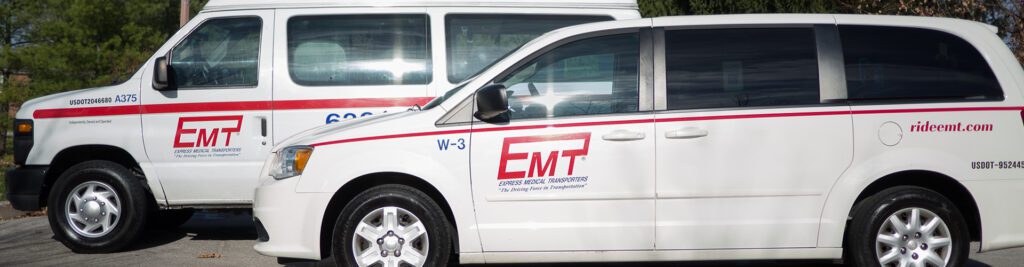 Two white vans with the logo of emp parked together